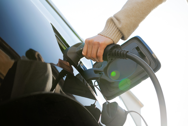 Close up of electric vehicle charging cable being inserted