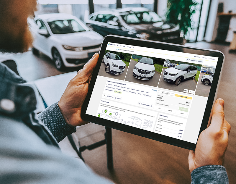 Dealer Auction website on a table in car dealership