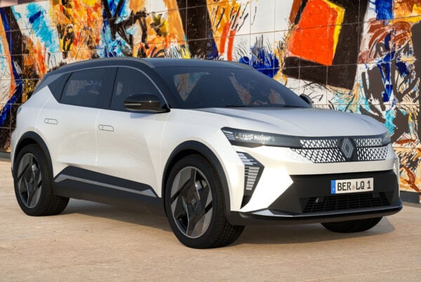 white renault scenic e-tech in front of graffiti wall